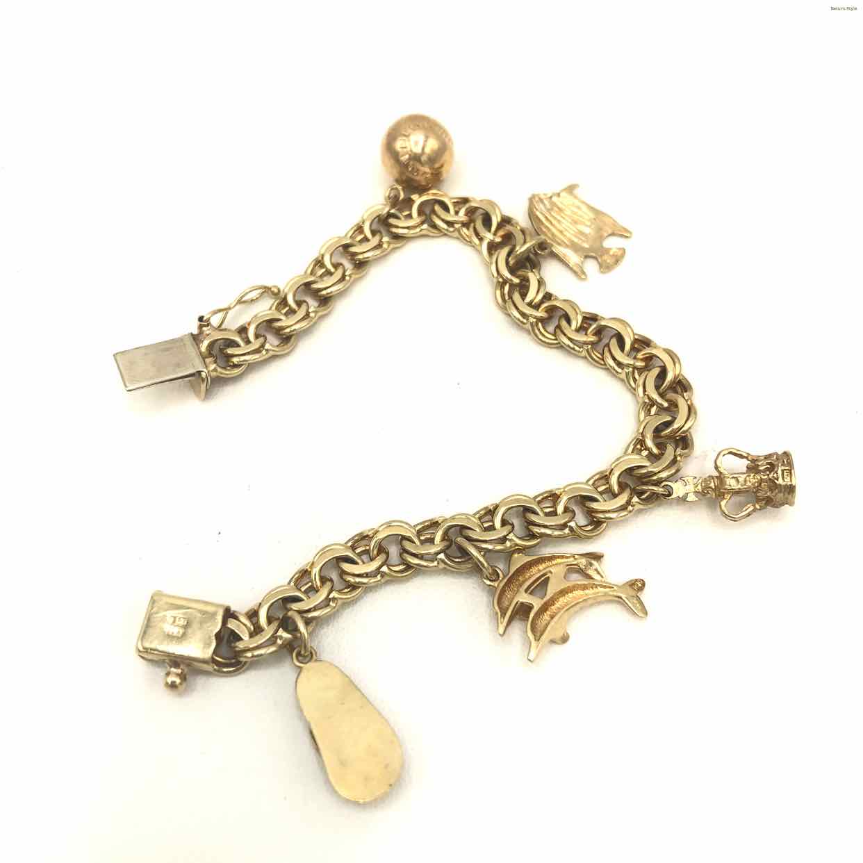 Lot 35: 14K Gold Charm Bracelet, 86.2 grams | Case Auctions